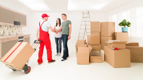 Removal crew carrying boxes through a central London apartment building