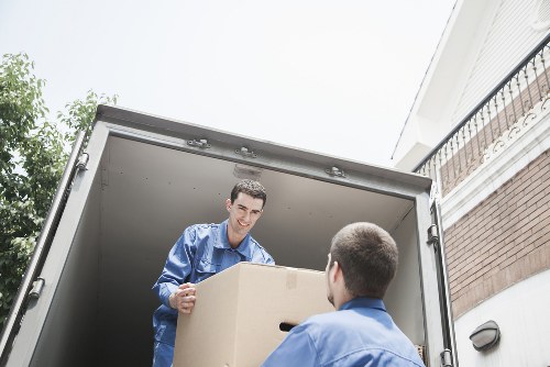 Mover wearing PPE while loading items into a van
