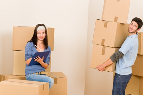 Careful movers handling boxes and household items in a Marylebone flat